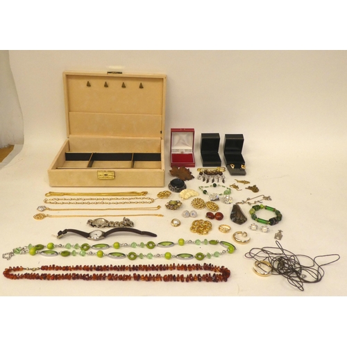 71 - Costume jewellery: to include brooches and necklaces, in a beige faux suede box