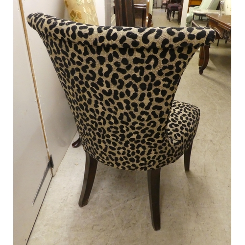 84 - Chairs: to include a bedroom chair, upholstered in leopard print fabric, raised on splayed feet