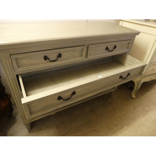 89 - A modern blue painted dressing chest with two short/three graduated long drawers, raised on turned f... 