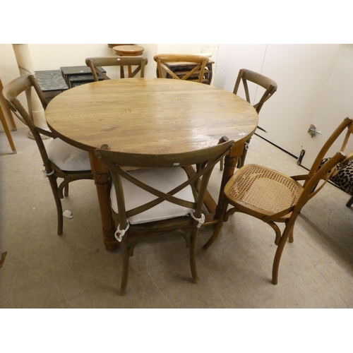 90 - A modern light oak dining table, raised on turned legs  30