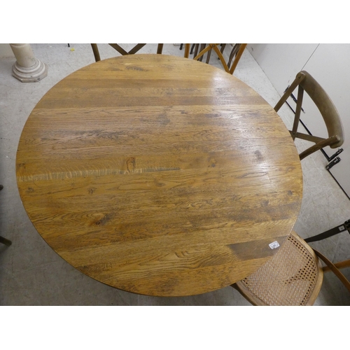 90 - A modern light oak dining table, raised on turned legs  30