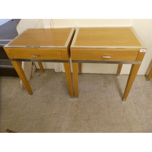 92 - A pair of modern light oak lamp tables, each with chrome trim and a drawer, raised on square legs&nb... 