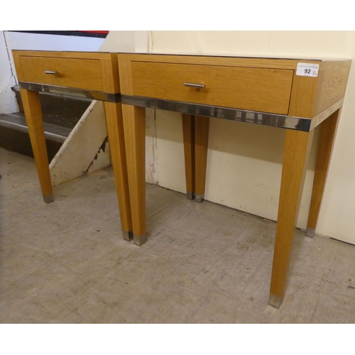 92 - A pair of modern light oak lamp tables, each with chrome trim and a drawer, raised on square legs&nb... 