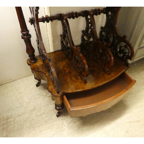 95 - A late Victorian walnut what-not Canterbury with a pierced gallery, over three divided sections and ... 