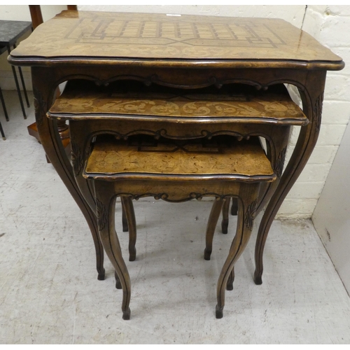 96 - A nesting set of three early 20thC beech and marquetry inlaid tables, raised on cabriole legs  large... 