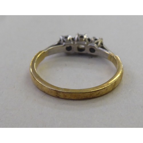 180 - An 18ct gold three stone, claw set diamond ring