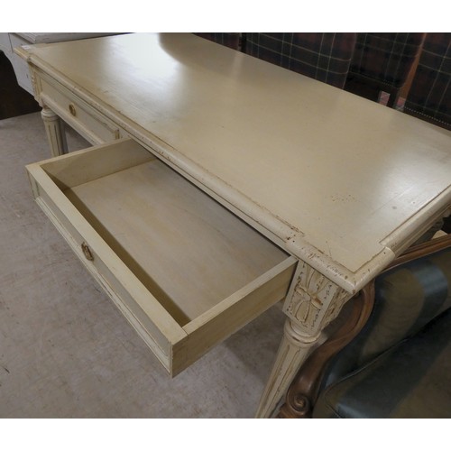 53 - A modern cream painted, distressed oak desk with two drawers, raised on turned, fluted legs  30