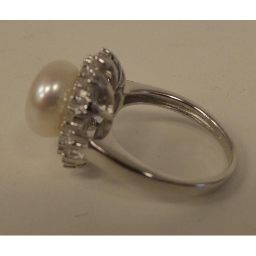 100 - A silver mounted freshwater pearl and cubic zirconia set ring  stamped 925