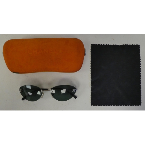 104 - A pair of Chanel sunglasses, in a dedicated orange hard case