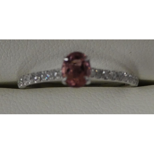 111 - A platinum mounted diamond and pink sapphire ring