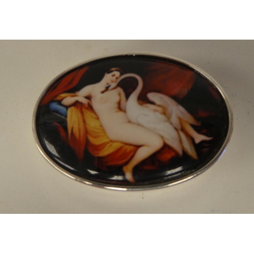 116 - A silver oval pill box, the hinged lid set with a coloured enamel tablet, depicting 'Leda and the Sw... 