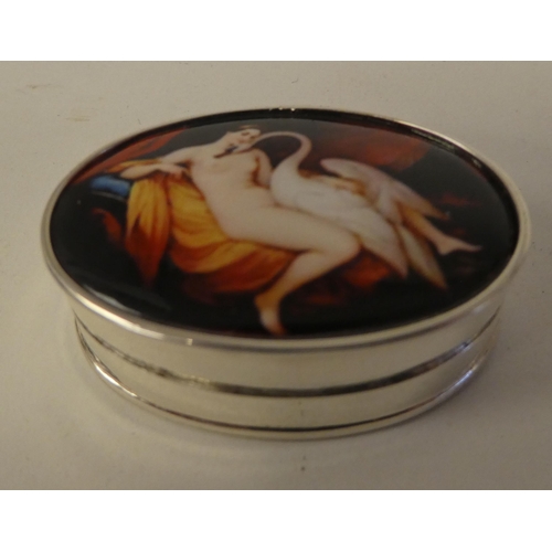 116 - A silver oval pill box, the hinged lid set with a coloured enamel tablet, depicting 'Leda and the Sw... 