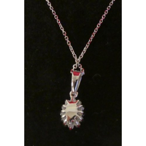 124 - An 18ct white gold, emerald and diamond set pendant, on a fine neckchain