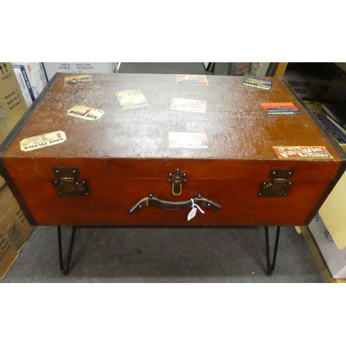 135 - A vintage suitcase table, finished in reinforced hide, bears various luggage labels, raised on steel... 