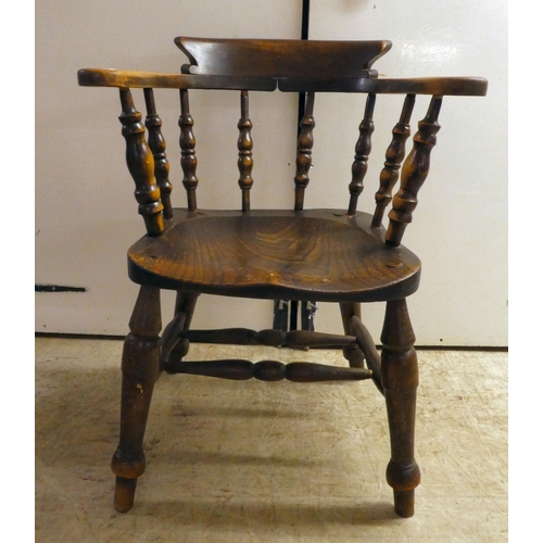 141 - An early 20thC beech and elm framed captain's design desk chair, the solid seat raised on turned leg... 