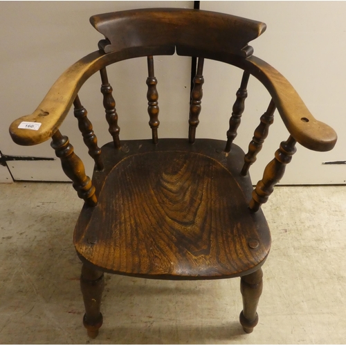 141 - An early 20thC beech and elm framed captain's design desk chair, the solid seat raised on turned leg... 
