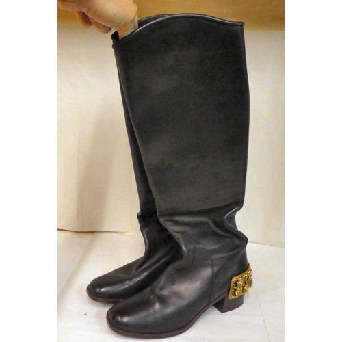 159 - A pair of Chanel black leather pull-on, riding style boots with block heels and heavy gilt coloured ... 