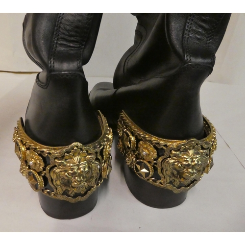 159 - A pair of Chanel black leather pull-on, riding style boots with block heels and heavy gilt coloured ... 