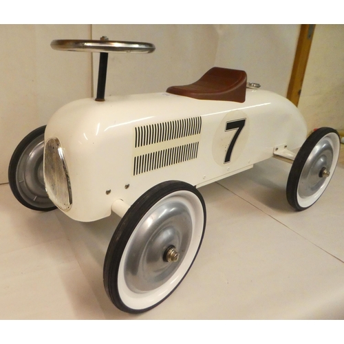 210 - A child's vintage design, enamelled steel and chromium plated sit-on-ride car with steering and rubb... 