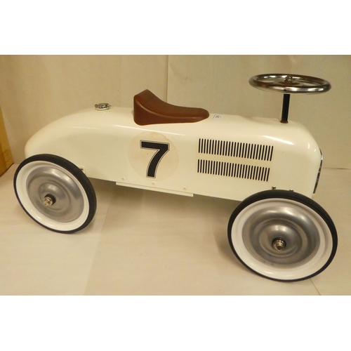 210 - A child's vintage design, enamelled steel and chromium plated sit-on-ride car with steering and rubb... 