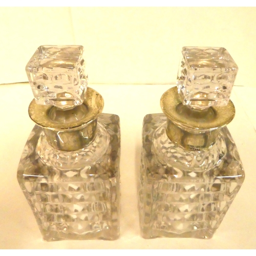 215 - Two moulded, shouldered, square glass decanters with silver collars  modern Birmingham marks