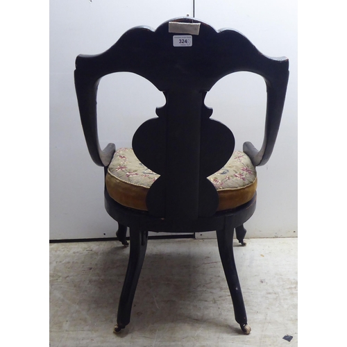 324 - A Regency black lacquered, overpainted, mother-of-pearl inlaid and gilded splat back nursing chair w... 