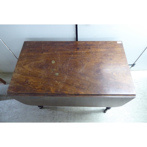 329 - A late Victorian mahogany Pembroke table, raised on ting turned, tapered legs and brass capped caste... 