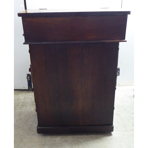 331 - A late Victorian rosewood veneered Davenport with a bank of four right hand drawers, on a concave pl... 