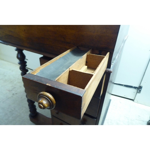 331 - A late Victorian rosewood veneered Davenport with a bank of four right hand drawers, on a concave pl... 