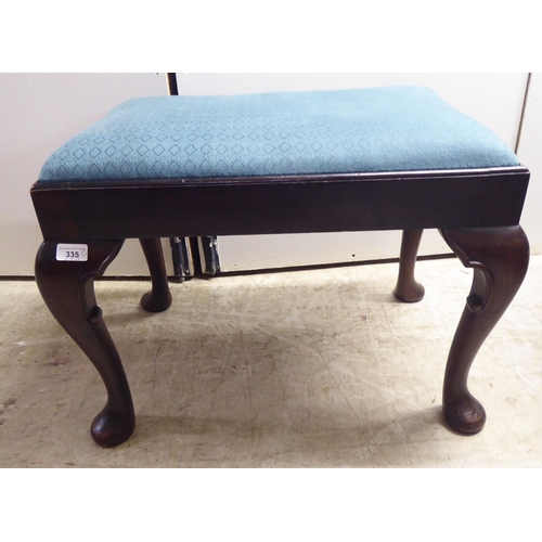 335 - A 1930s mahogany framed stool, raised on cabriole legs and pad feet 