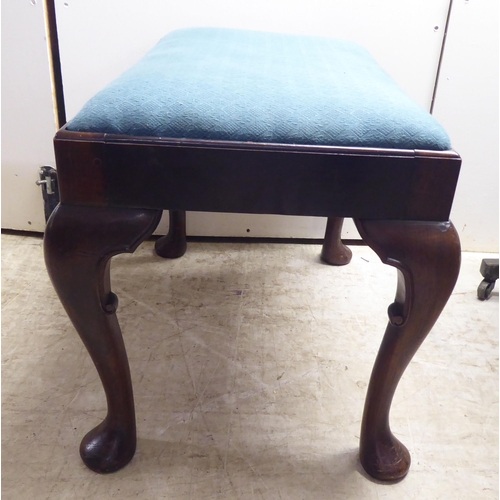 335 - A 1930s mahogany framed stool, raised on cabriole legs and pad feet 