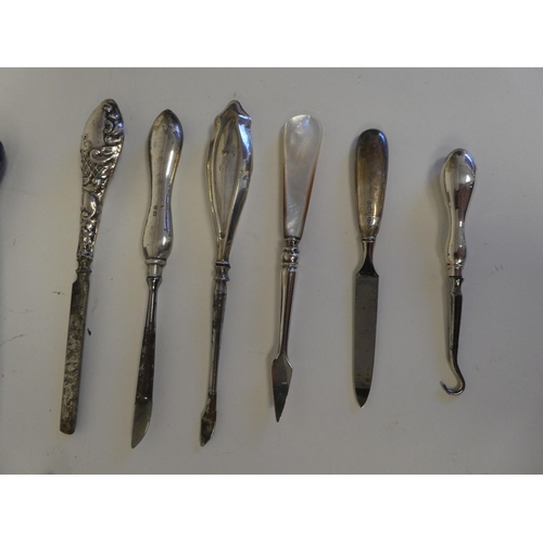 48 - Silver and white metal items: to include spoons; a pepper mill; and hair brushes  mixed marks