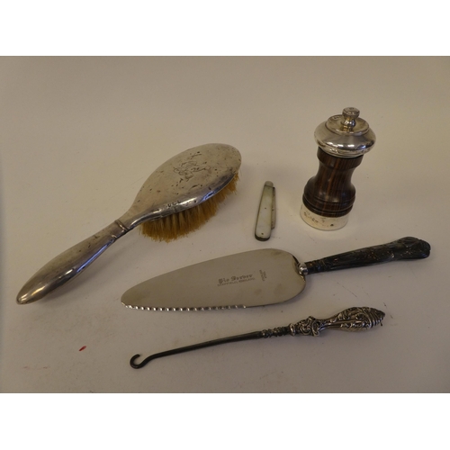48 - Silver and white metal items: to include spoons; a pepper mill; and hair brushes  mixed marks