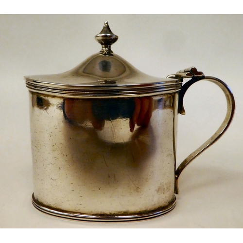 99 - A Georgian style silver oval mustard pot with applied wire ornament, a hinged lid and loop handle wi... 