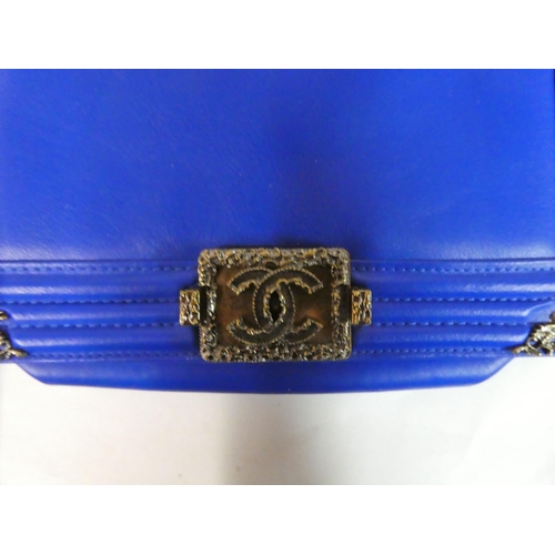 110 - A Chanel electric blue leather handbag with decorative metal mounts and chain