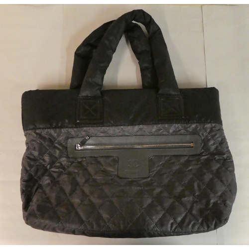 112 - A Chanel black quilted fabric tote bag with dust cover