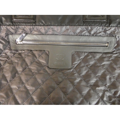 112 - A Chanel black quilted fabric tote bag with dust cover