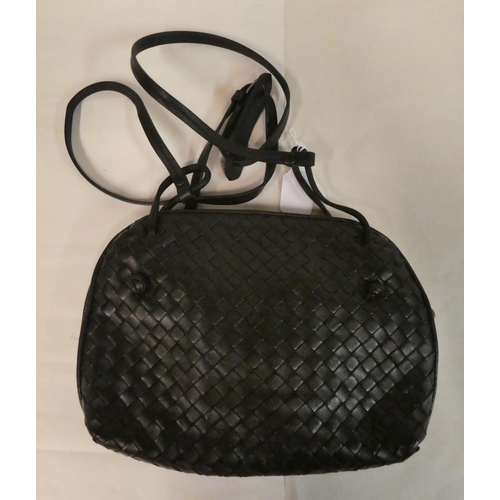 118 - A Bottega Veneta woven black leather shoulder bag with a dust cover; and a Marc by Marc Jacobs dark ... 