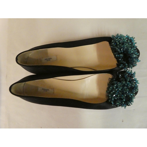 126 - Two pairs of black pumps, viz. Chanel with lace bows  size 40; and Prada, decorated with turquo... 