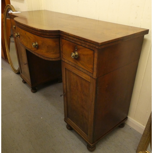 161 - A mid Victorian mahogany one-piece break bow front serving sideboard with three frieze drawers, over... 