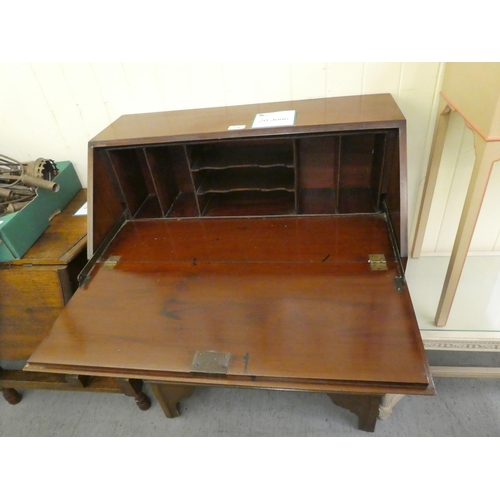 176 - An Edwardian mahogany three drawer bureau, raised on bracket feet  38