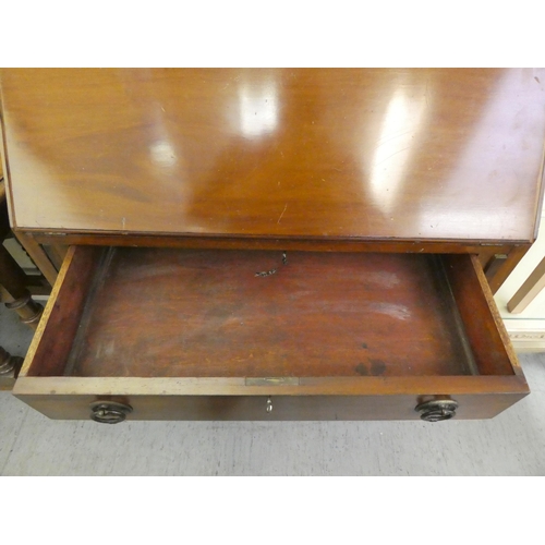 176 - An Edwardian mahogany three drawer bureau, raised on bracket feet  38