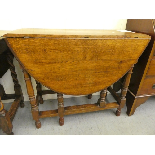 181 - Two 1930s oak drop leaf dining tables, raised on turned legs  30