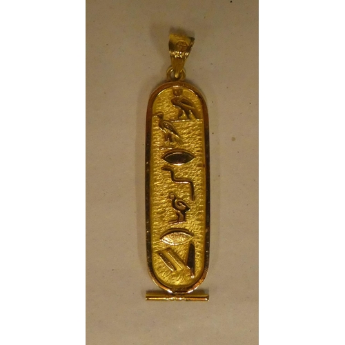 319 - An Egyptian style yellow metal and decorated lozenge tablet pendant