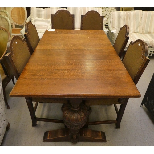 87 - A mid 20thC oak refectory style dining table, raised on opposing baluster carved uprights and platfo... 