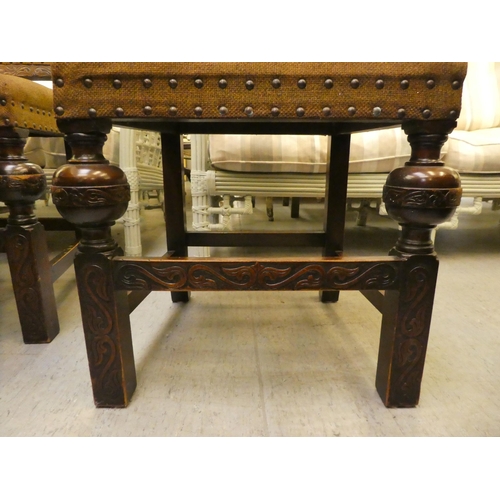 87 - A mid 20thC oak refectory style dining table, raised on opposing baluster carved uprights and platfo... 