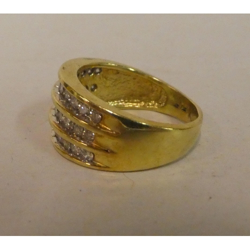 An 18ct gold ring, set with three rows of diamonds