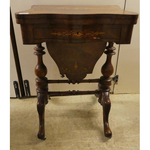 169 - A late Victorian string inlaid walnut veneered combination games/sewing table with a rotating foldov... 