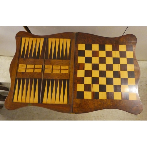 169 - A late Victorian string inlaid walnut veneered combination games/sewing table with a rotating foldov... 