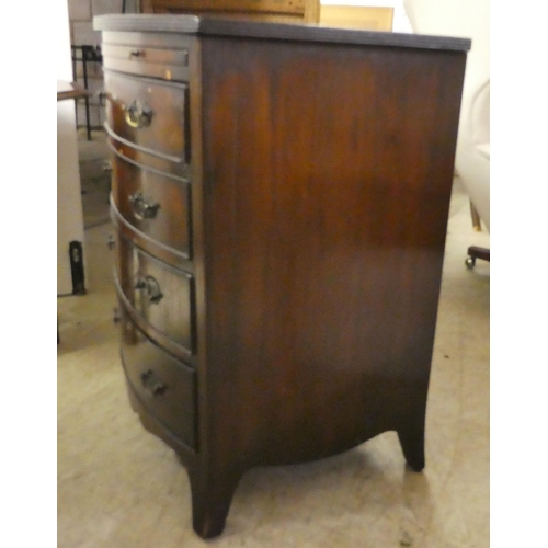 177 - An early/mid 20thC mahogany bow front bachelor's chest with a brushing slide, over four drawers, rai... 